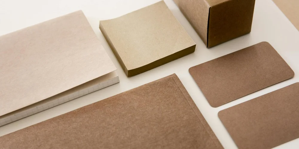 Assorted beige and brown cardboard boxes arranged on a light surface.