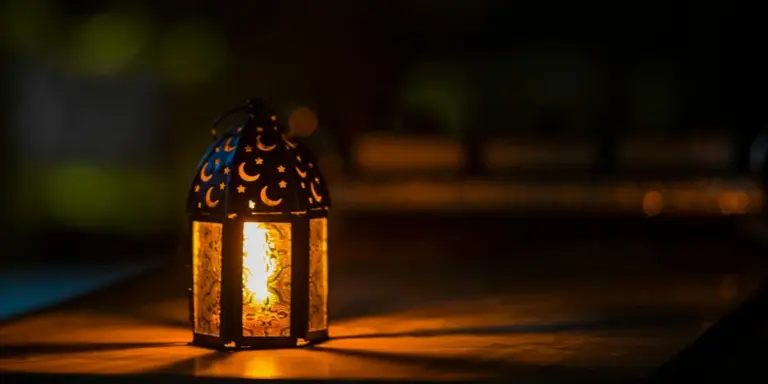 Decorative lantern-style heat lamp glowing warmly at night.
