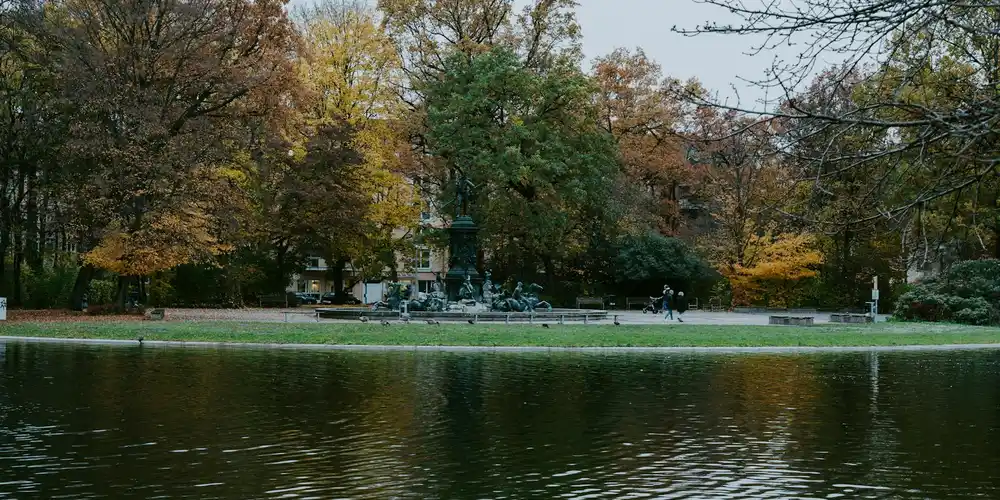Park pond with autumn trees reflected in the water, illustrating the importance of monitoring water quality for turtle habitats.