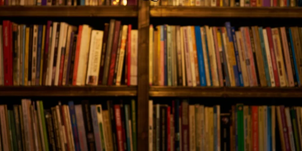Wooden bookshelf filled with a variety of colorful books and guides on reptile care
