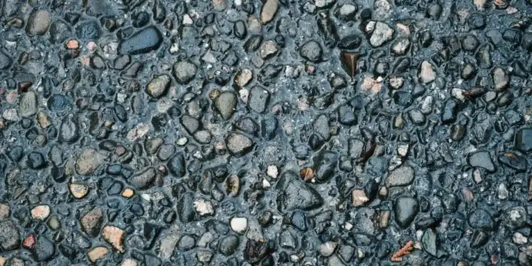 Close-up of a gravel substrate with mixed gray and tan pebbles.