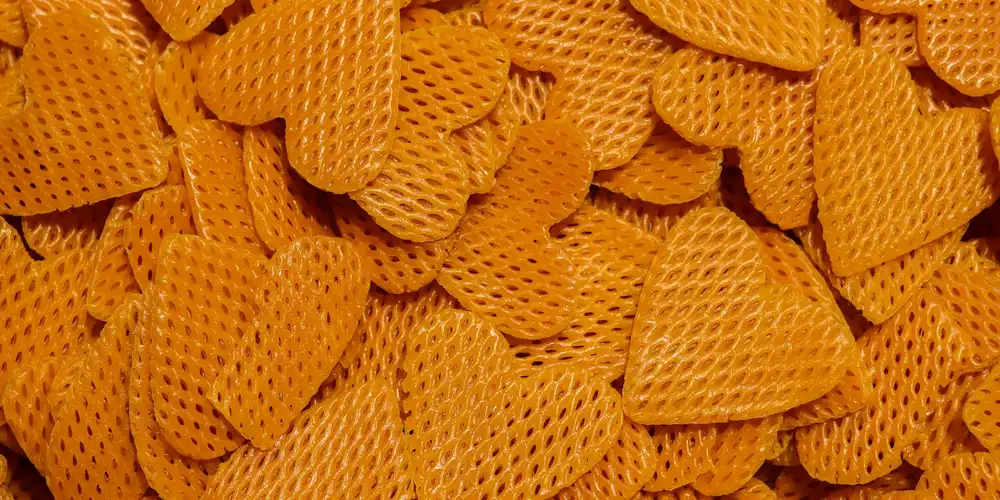 Close-up of bright orange commercial turtle food pellets