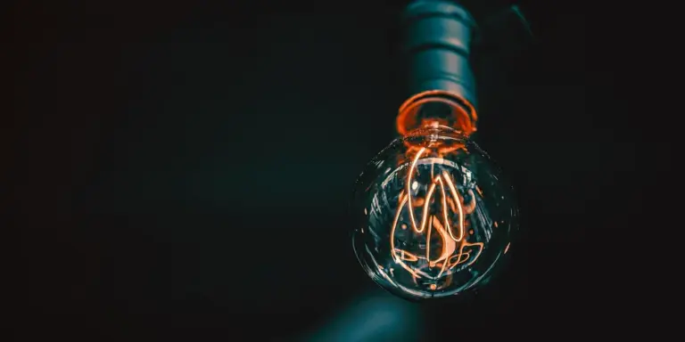 Close-up of a glowing bulb in a dark background, illustrating UVB lighting for turtle habitats.